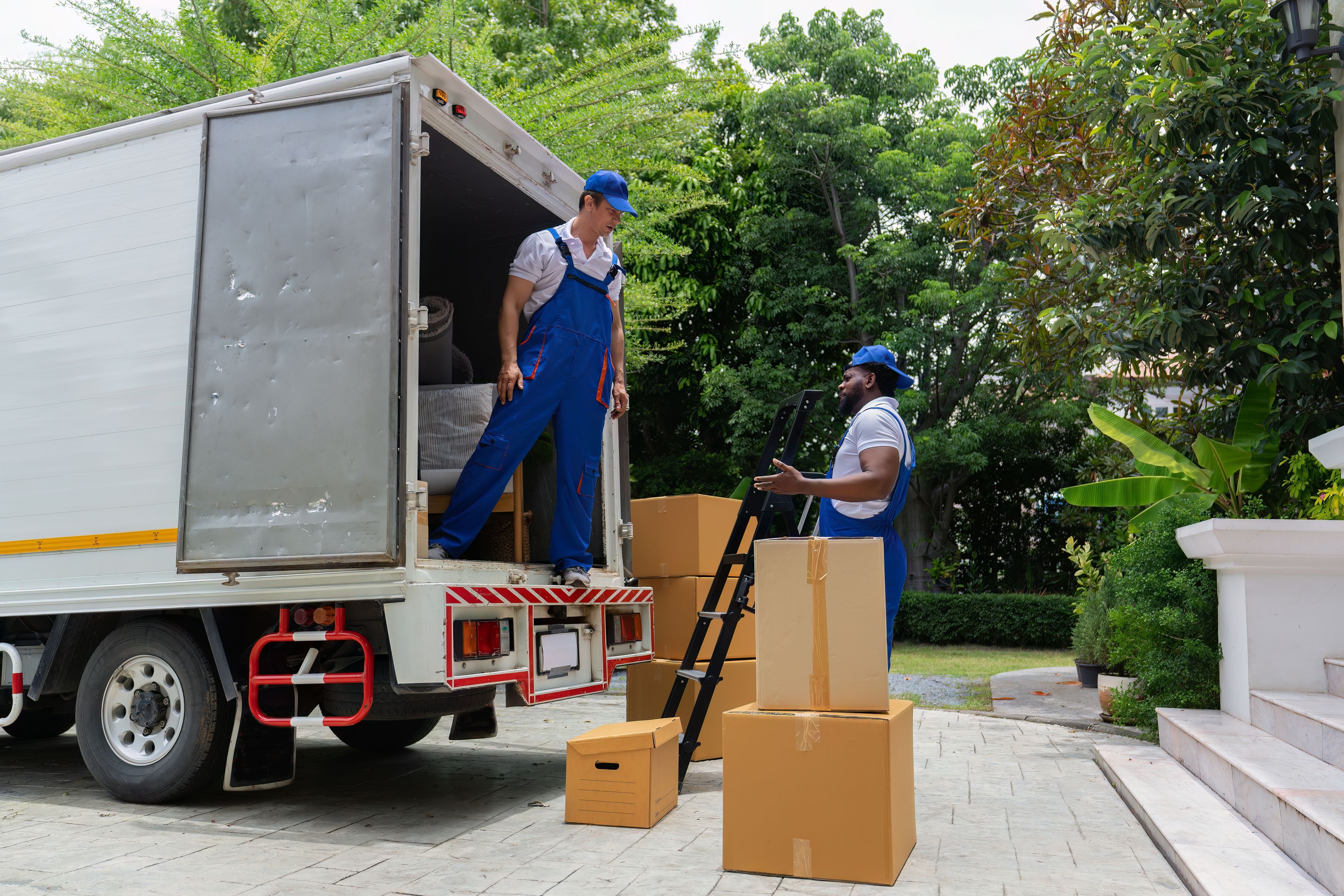Family sitting around a fire pit in front of cabin